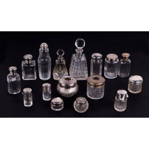 517 - A quantity of silver topped dressing table jars and bottles, various dates and makers marks.