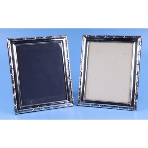 518 - A large pair of silver strut photo frames, overall 25 by 30cms (2).