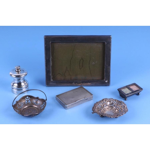 521 - A silver strut phot frame; together with a silver pepper grinder; a silver stamp box; a silver cigar... 