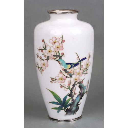 625 - A Japanese cloisonne vase decorated with a bird and flowering cherry tree, on a white ground, 19cms ... 