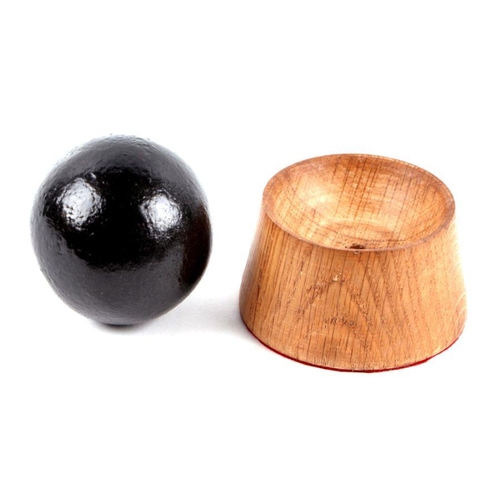 88 - An iron cannon ball. Approximate diameter of 7cms (2.75ins) on a turned oak mount