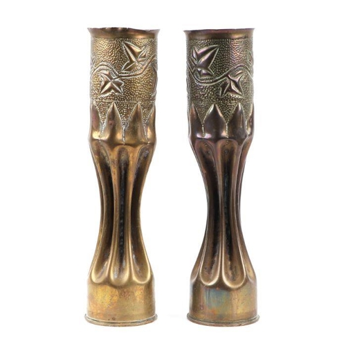 90 - A matching pair of WW1 trench art fluted shell cases inscribed with foliage. 34cms (13.375ins) by 8.... 