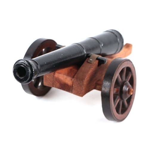 93 - A large desk top cannon with a 37cms (14.5ins) long alloy barrel mounted on a wooden carriage and wh... 