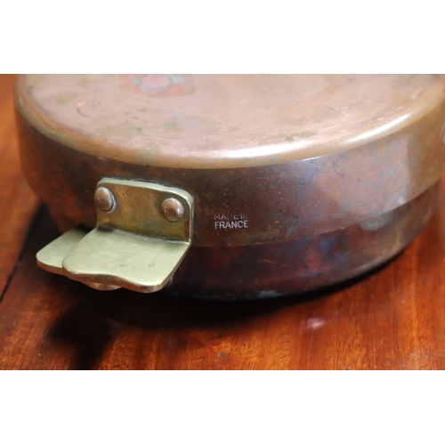 394 - A Victorian copper jelly mould, 23cms diameter; together with a copper pan and cover, 17cms wide; an... 