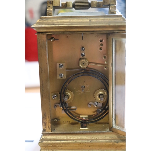 459 - A late 19th century French brass four-pillar carriage clock, the white dial with Roman and Arabic nu... 