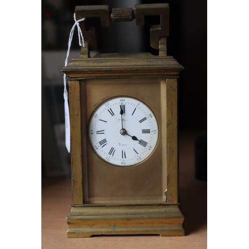 459 - A late 19th century French brass four-pillar carriage clock, the white dial with Roman and Arabic nu... 