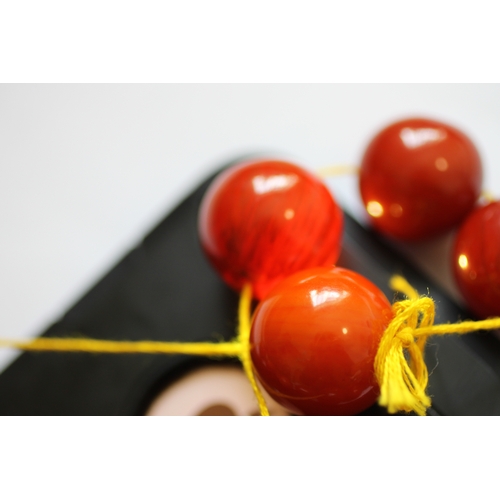 523 - A butterscotch Bakelite amber bead necklace, the largest bead approx 3cms long.