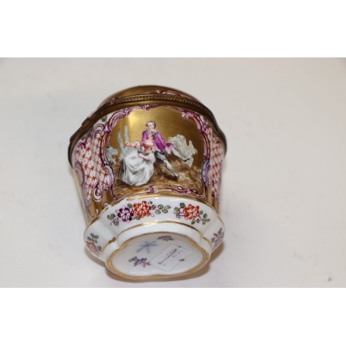 310 - A continental porcelain box and cover decorated with classical figures, 9.5cms high; together with t... 