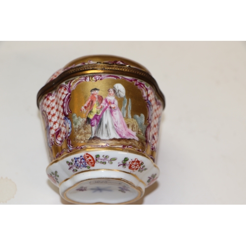 310 - A continental porcelain box and cover decorated with classical figures, 9.5cms high; together with t... 