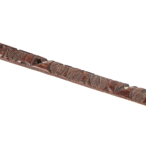 101 - A Maori carved hardwood walking stick, the shaft carved with Koruru (owl), 86cms long.