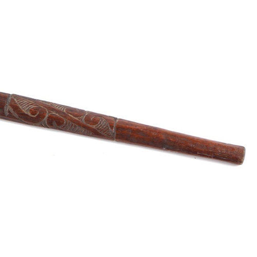 101 - A Maori carved hardwood walking stick, the shaft carved with Koruru (owl), 86cms long.