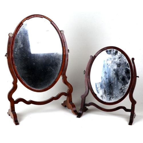 1056 - A 19th century mahogany framed oval toilet mirror, 34cms wide; together with a similar smaller, 28cm... 