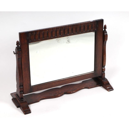 1057 - An oak framed dressing table mirror, 69cms wide.