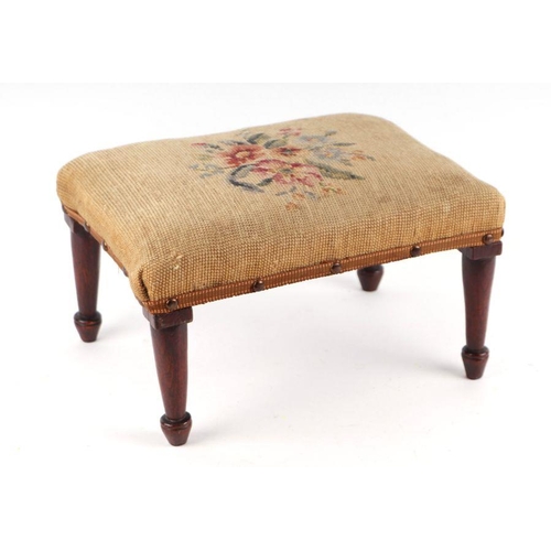 1058 - A 19th century provincial oak footstool with needlework cover, tapering legs terminating in circular... 