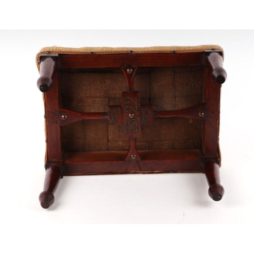 1058 - A 19th century provincial oak footstool with needlework cover, tapering legs terminating in circular... 