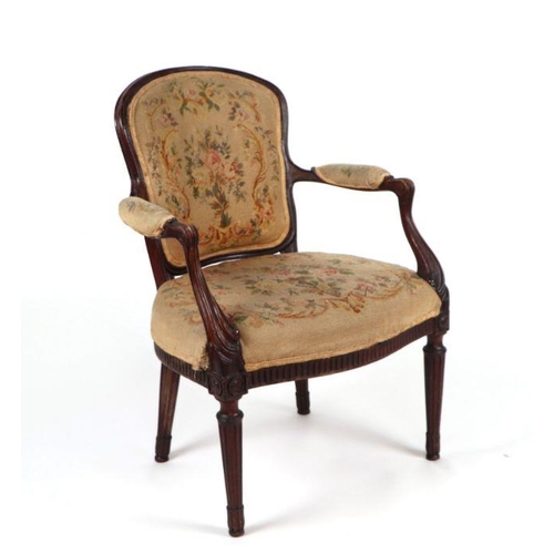 1062 - A Louis XVI style open armchair with embroidered back and seat, carved scroll arms and reeded taperi... 