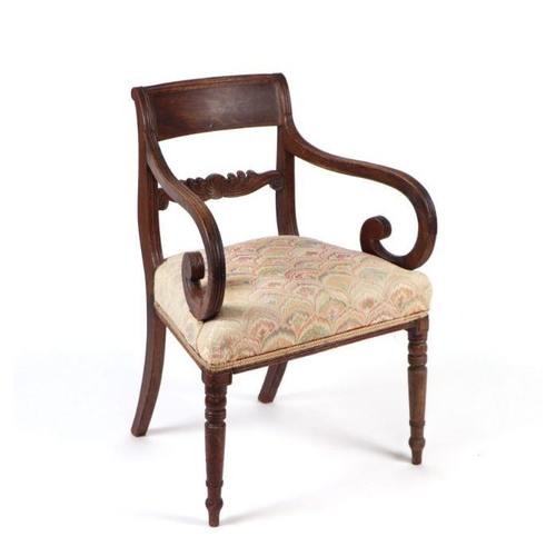 1063 - A 19th century mahogany open armchair with carved scroll arms and ring turned tapering front legs; t... 