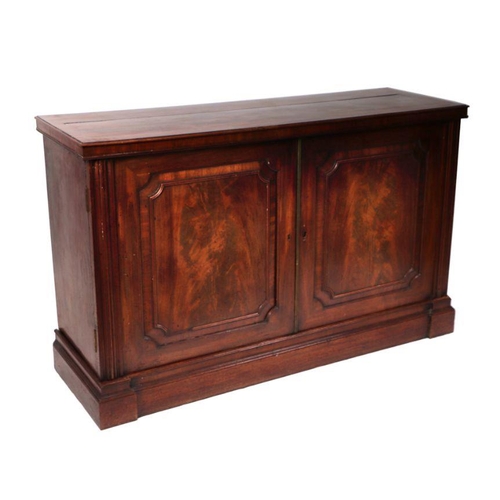 1068 - A 19th century mahogany side cabinet, the pair of panelled doors enclosing a shelved interior, on a ... 