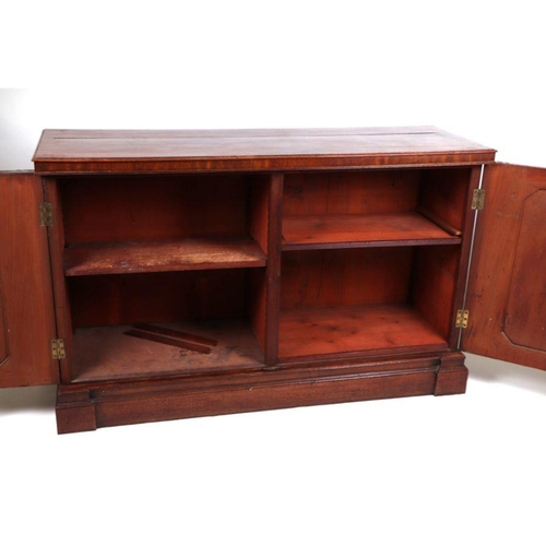 1068 - A 19th century mahogany side cabinet, the pair of panelled doors enclosing a shelved interior, on a ... 