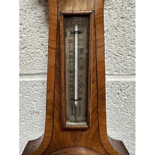 111 - A John Barker & Co. of Kensington barometer thermometer in a walnut case, 55cms high.