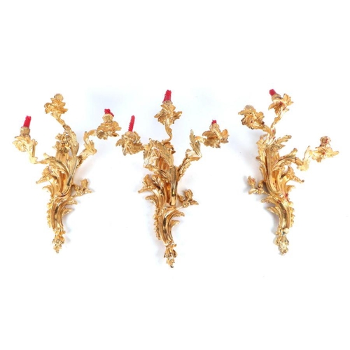 119 - A set of three rococo style gilt metal wall sconces, each approx 50cms high (3).