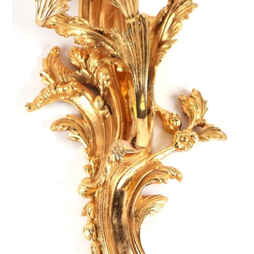 119 - A set of three rococo style gilt metal wall sconces, each approx 50cms high (3).