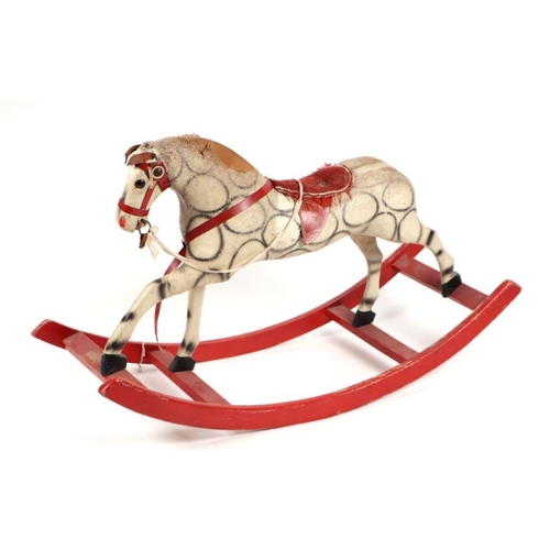 124 - An early 20th century straw filled rocking horse, possibly German. 105cm long (a/f)