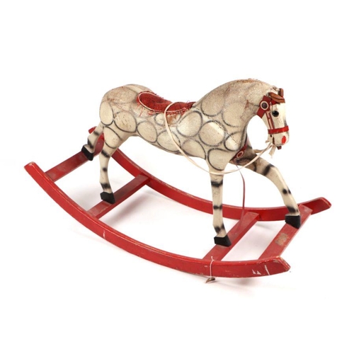 124 - An early 20th century straw filled rocking horse, possibly German. 105cm long (a/f)