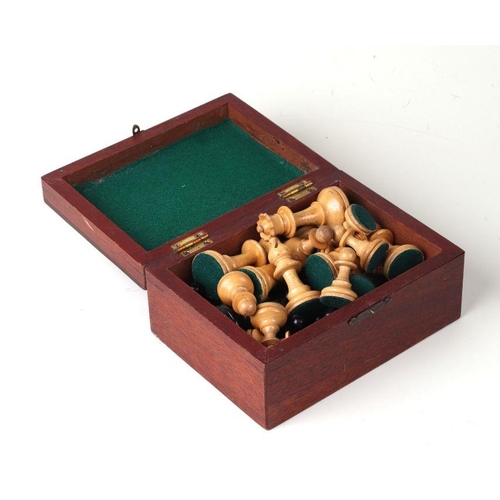 128 - A boxwood and ebonised chess set in a mahogany box, the king height 7.5cms.