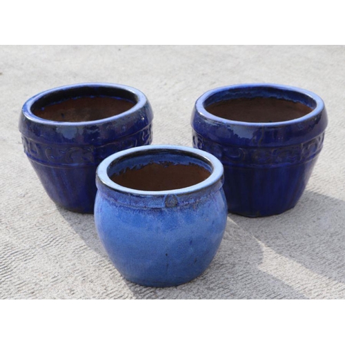 13 - A pair of blue glazed garden planters, 34cms diameter; together with a similar smaller, 28cms diamet... 