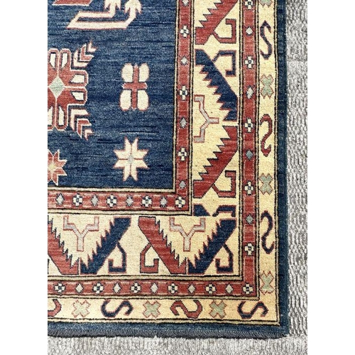 169 - A Pakistan hand knotted rug with geometric Kazak design, 386 by 262cms.