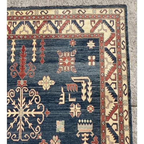 169 - A Pakistan hand knotted rug with geometric Kazak design, 386 by 262cms.