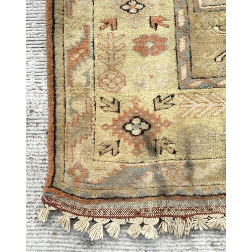 176 - A Persian hand knotted rug decorated with a geometric pattern on a beige ground, 196 by 281cms.