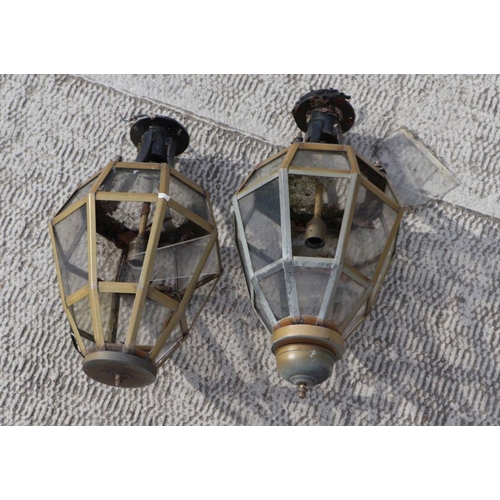 21 - A large pair of outdoor wall lamps of octagonal form, on metal brackets, 76cms high; together with a... 