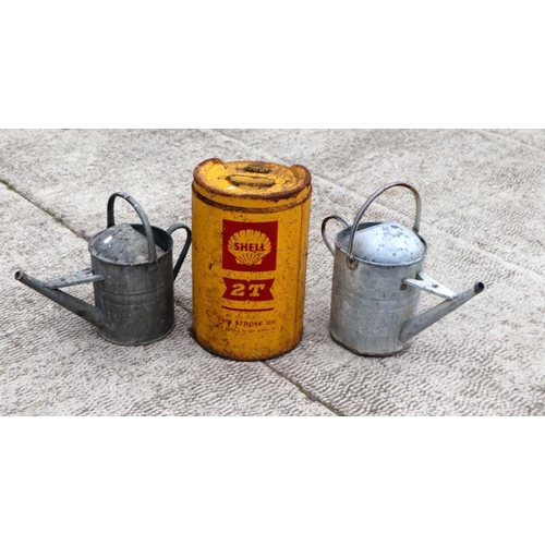 4 - Two galvanised watering cans; together with a Shell two-stroke oil can (3).