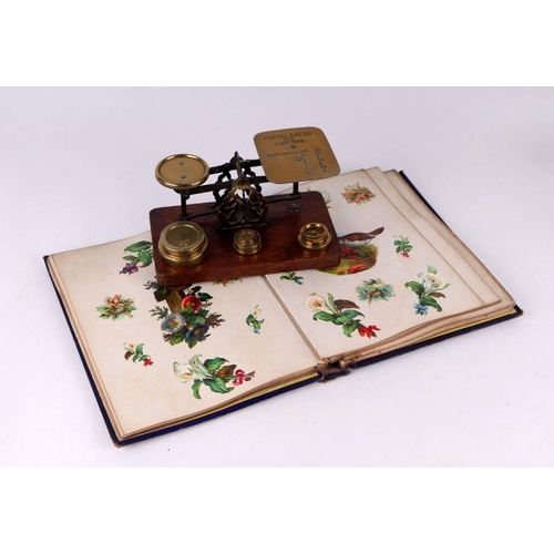 44 - A Victorian scrap album; together with a set of brass and oak postal scales.