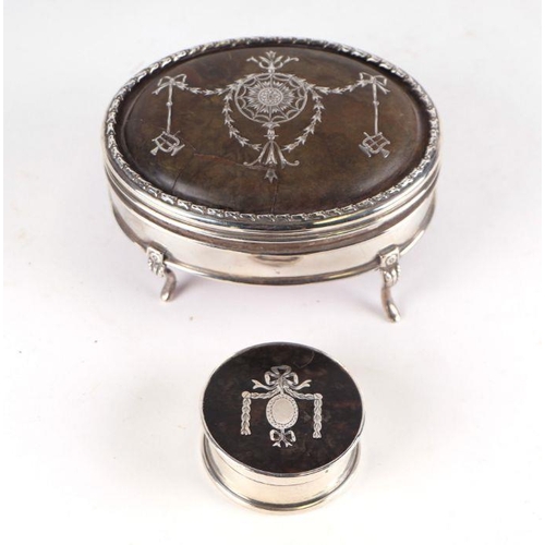 510 - A George V silver and tortoiseshell oval trinket box, the lid inlaid with swag decoration, on acanth... 