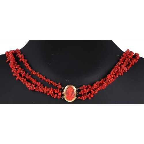 518 - A Victorian coral three-strand necklace with yellow coloured metal clasp and coral cameo in the form... 