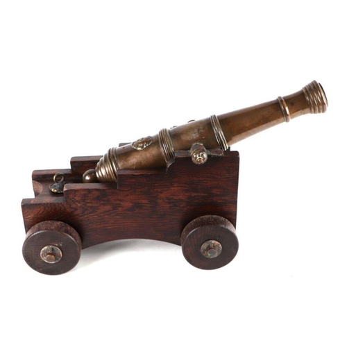 81 - A 19th century bronze signal cannon, 44cms long, on a later wooden carriage.