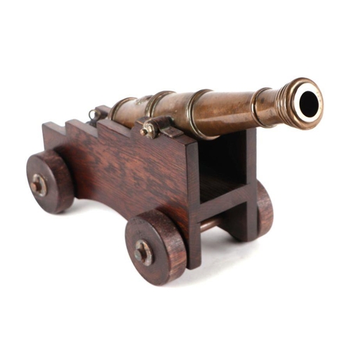 81 - A 19th century bronze signal cannon, 44cms long, on a later wooden carriage.