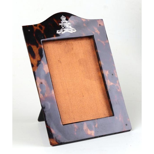 89 - A Royal Artillery white metal mounted tortoiseshell strut photograph frame, overall 14 by 20cms.