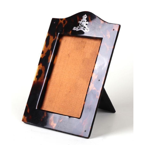 89 - A Royal Artillery white metal mounted tortoiseshell strut photograph frame, overall 14 by 20cms.