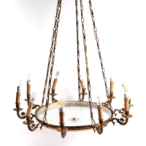 112A - A cut glass and brass ten-arm ceiling light, 84cms wide.