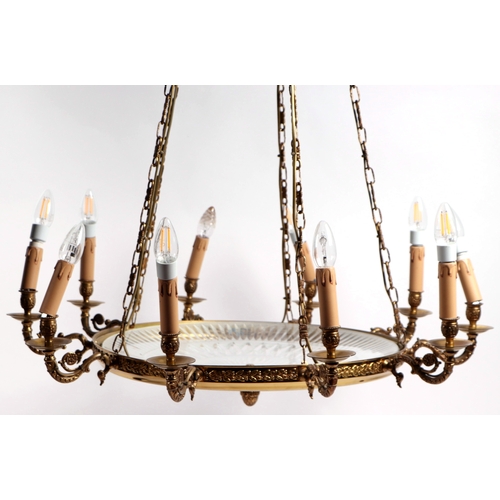 112A - A cut glass and brass ten-arm ceiling light, 84cms wide.