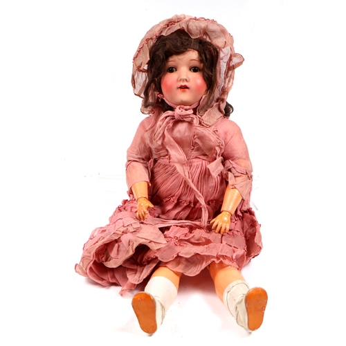 126 - A bisque headed doll.