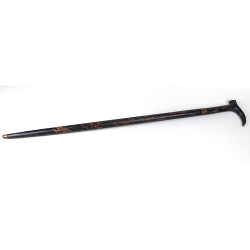 52 - An Anglo-Indian sword stick with carved decoration, 95cms long, blade length 46cms.