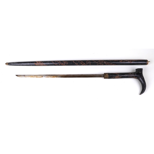 52 - An Anglo-Indian sword stick with carved decoration, 95cms long, blade length 46cms.