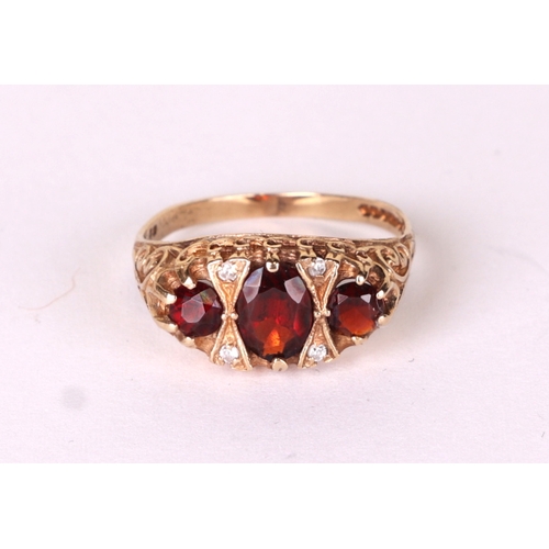 525A - A 9ct gold garnet and diamond ring, approx UK size 'P', 3.1g.