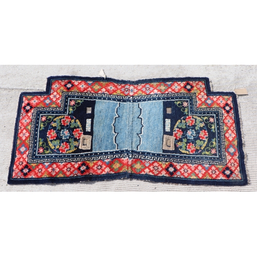 174 - A Tibetan saddle blanket; together with three Tibetan hand knotted meditation rugs, the largest 88 b... 