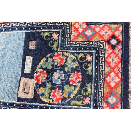 174 - A Tibetan saddle blanket; together with three Tibetan hand knotted meditation rugs, the largest 88 b... 